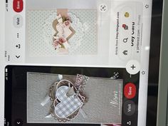 a cell phone with an image of a heart on the screen and some cards attached to it