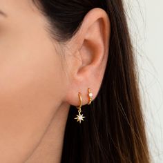 "Delicate huggie hoop earrings with a small dainty star charm. Understated and elegant, these dainty hoops will mix and match effortlessly with other earrings and are perfect for everyday wear. ∙ Sold individually (1 earring) or by pair (2 earrings) * D E T A I L S * ∙ Material: .925 Sterling Silver or 18K Gold Plated over .925 Sterling Silver ∙ Stone: White Zirconia ∙ Dimensions: Inner diameter: 9mm // Star charm: 8mm ∙ Hypoallergenic & nickel-free * P A C K A G I N G * ∙ All jewelry is sen Small Star Hoop Earrings, Star Huggie Earrings, Gold Aesthetic Earrings, Sterling Silver Celestial Hoop Earrings With Star Charm, Celestial Sterling Silver Hoop Earrings With Star Charm, Celestial Huggie Earrings With Star Charm Dangle, Celestial Dangle Huggie Earrings With Star Charm, Celestial Hoop Earrings With Star Charm For Everyday, Celestial Small Hoop Earrings With Star Charm