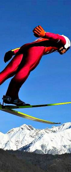 a man flying through the air while riding skis