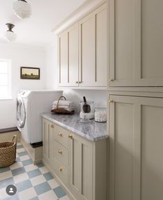 a white and blue checkered floor in a laundry room next to a washer and dryer