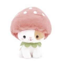 a small stuffed animal with a mushroom on it's head, sitting in front of a white background