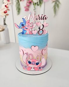 there is a birthday cake with pink and blue frosting on the top that says maria