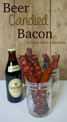 a glass jar filled with bacon next to a bottle of beer