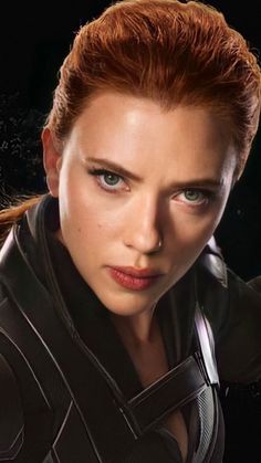 a woman with red hair and blue eyes in black widow suit looking at the camera