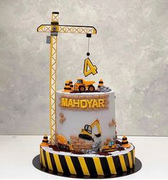 there is a cake that has construction equipment on it and the name mahdaar