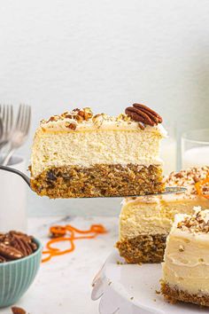 a slice of carrot cake being lifted from a plate with the rest of the cake