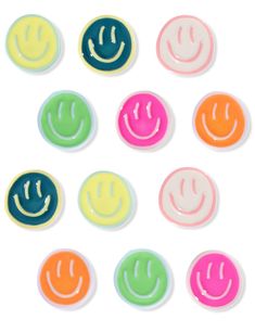 six different colored buttons with smiley faces in the middle and one has a smile on it