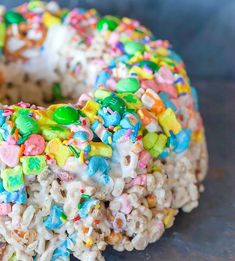 a sprinkle covered donut is sitting on a table with cereal all over it