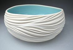 a white and blue bowl sitting on top of a table