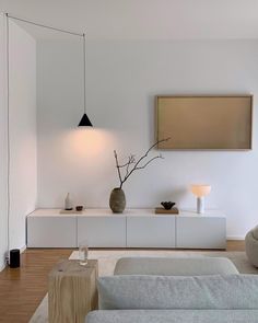 a living room with white walls and furniture