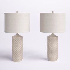 This 2-piece set of table lamps adds the finishing, classic touch to your living room or bedroom. Each is crafted from polyresin in a cylindrical shape with a geometric, textured pattern. The design features an elegant drum shade made from a poly-blend fabric in a timeless ivory hue topped with a finial. This pair of table lamps plug-in with a standard cord, turns on with a 3-way switch, and each takes one standard bulb (sold separately). Arrange them by framing your sofa or headboard. Lark Mano Concrete Table Lamp, Concrete Table, Table Lamp Sets, White Table Lamp, Resin Table, Ceramic Table Lamps, Lamp Sets, Ceramic Table, Drum Shade