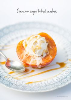 a white plate topped with an orange covered in ice cream