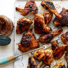 grilled chicken with bbq sauce on a tray next to a jar of ketchup