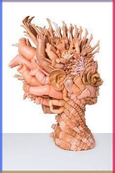 there is a sculpture made out of many different things in the shape of a woman's head