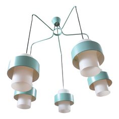 three light fixtures hanging from the ceiling with white and blue trims on each fixture