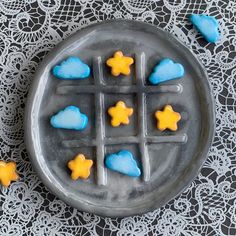 a plate with some cookies on it and blue icing in the shape of stars