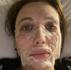 a woman with white facial mask on her face