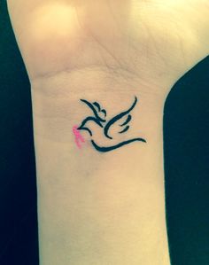 a small wrist tattoo with a bird on it's left arm and pink ribbon around the wrist