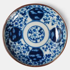 a blue and white bowl with flowers on it