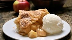 a slice of apple pie on a plate with ice cream