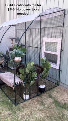 a small cage with plants in it sitting on the grass next to a building that says build a patio with me for $ 5 each needs needed