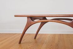 a wooden bench sitting on top of a hard wood floor