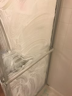 a shower door with white paint on it