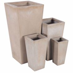 four cement vases are stacked on top of each other