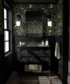 a bathroom with black and green wallpaper, dark wood flooring and two sinks