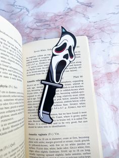 an open book with a black and white sticker on it