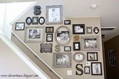 the stairs are decorated with many pictures and letters on them, as well as framed photos