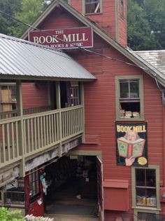 a red building with a sign that reads book mill