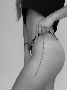 a woman's lower back with writing on her leg and the word love written in cursive font