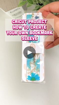 a person holding a bookmark in their hand with the text cricut project how to create your own bookmark sleeve?