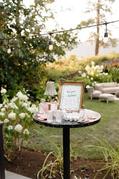 a table with a sign on it in the middle of a yard