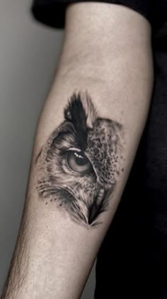 an owl's eye is shown on the left arm and behind it are a black - and - white tattoo