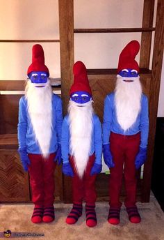 three gnomes dressed in blue and red standing next to each other