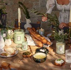 a table topped with lots of food and candles