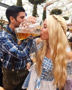 a man and woman drinking beer together at an outdoor event with the caption's name on it