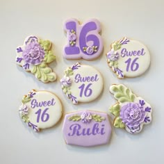 decorated cookies are arranged in the shape of flowers and numbers for sweet sixteen birthdays