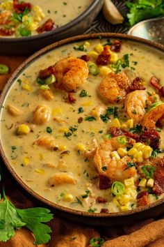 two bowls of soup with shrimp and corn