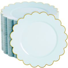 a stack of blue and white plates stacked on top of each other with gold scalloped edges