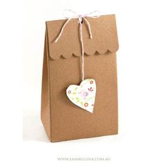 a brown paper bag with a heart hanging from it's front and back side