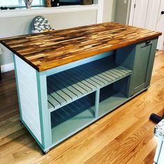 a kitchen island made out of wood and metal