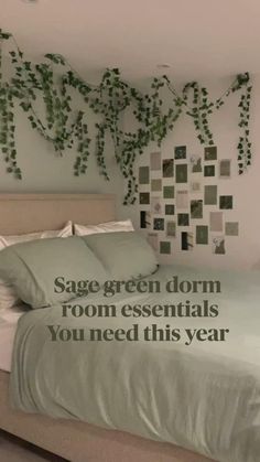 there is a bed with green leaves on the wall above it and an advertisement for sage green dorm room essentials you need this year