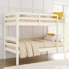 a white bunk bed sitting on top of a hard wood floor next to a window