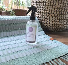 a bottle of hand sanitizer sitting on top of a rug next to a basket