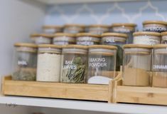 many jars with spices are on the shelf