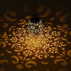 a light that is on in the dark with some lights coming from it and an intricate pattern