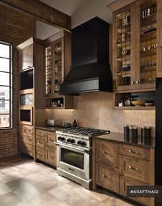 a kitchen with wooden cabinets and stainless steel stove top oven in the middle of it